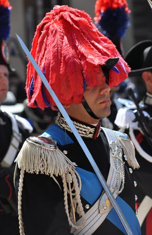 Un carabiniere in grande uniforme, con il pennacchio rosso e la sciabola